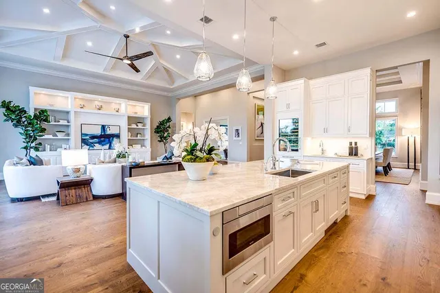 a large white kitchen with a large window