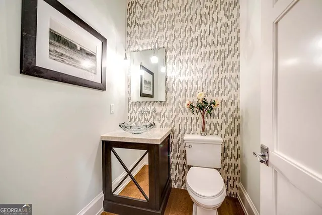 a white toilet sitting next to a shower curtain