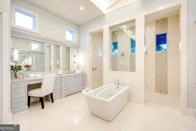 a bathroom with a tub sink and mirror