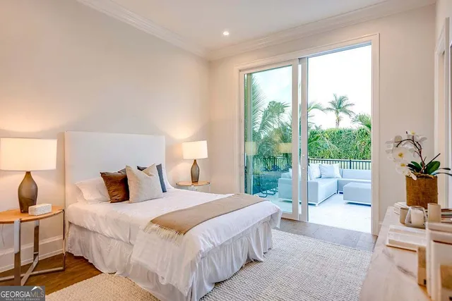 a bedroom with a large bed and a large window