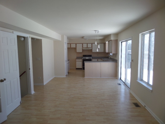 603 Buckboard Road Bolingbrook, IL 60490 - Photo 3 of 24 a kitchen with a refrigerator and a stove top oven