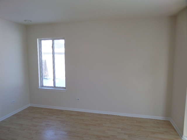 603 Buckboard Road Bolingbrook, IL 60490 - Photo 5 of 24 an empty room with wooden floor and windows