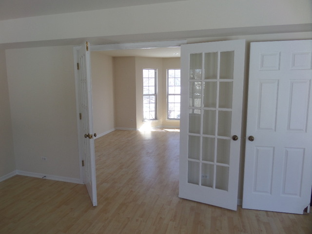 603 Buckboard Road Bolingbrook, IL 60490 - Photo 8 of 24 a view of a room with wooden floor and windows