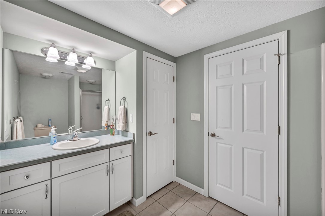 4741 Lake Road West Ashtabula, OH 44004 - Photo 38 of 43 Bathroom with vanity, a textured ceiling, and tile flooring