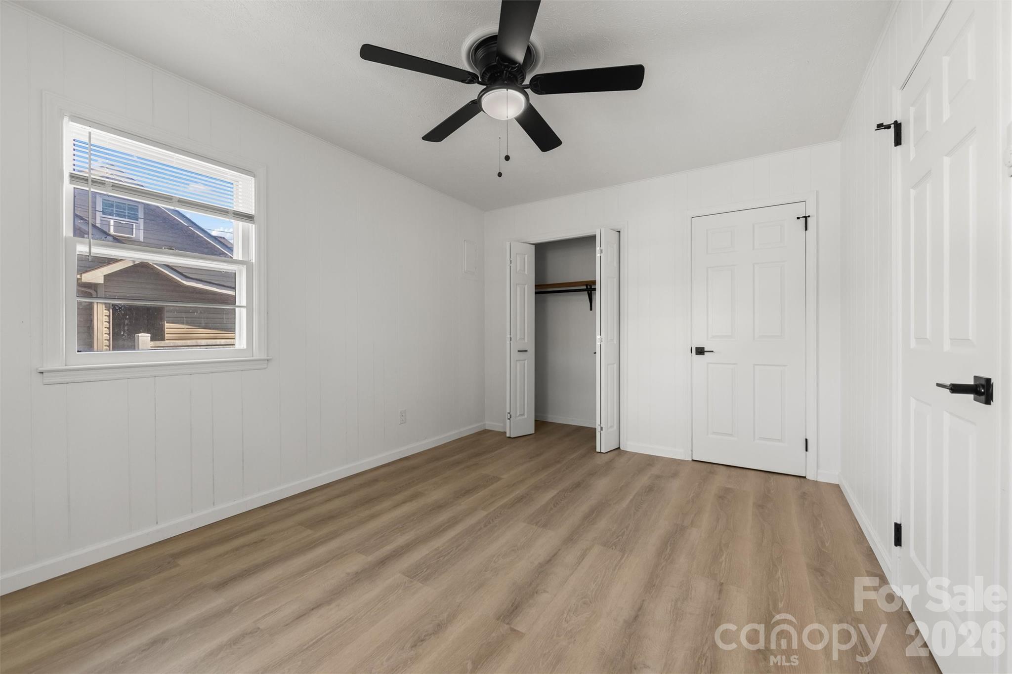 71 Maple Street Clyde, NC 28721 - Photo 11 of 22 a view of empty room with wooden floor
