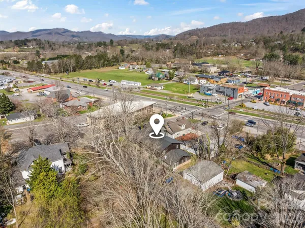 an aerial view of a house with a mountain