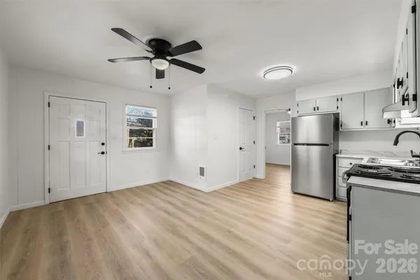a kitchen with cabinets stainless steel appliances and a counter space