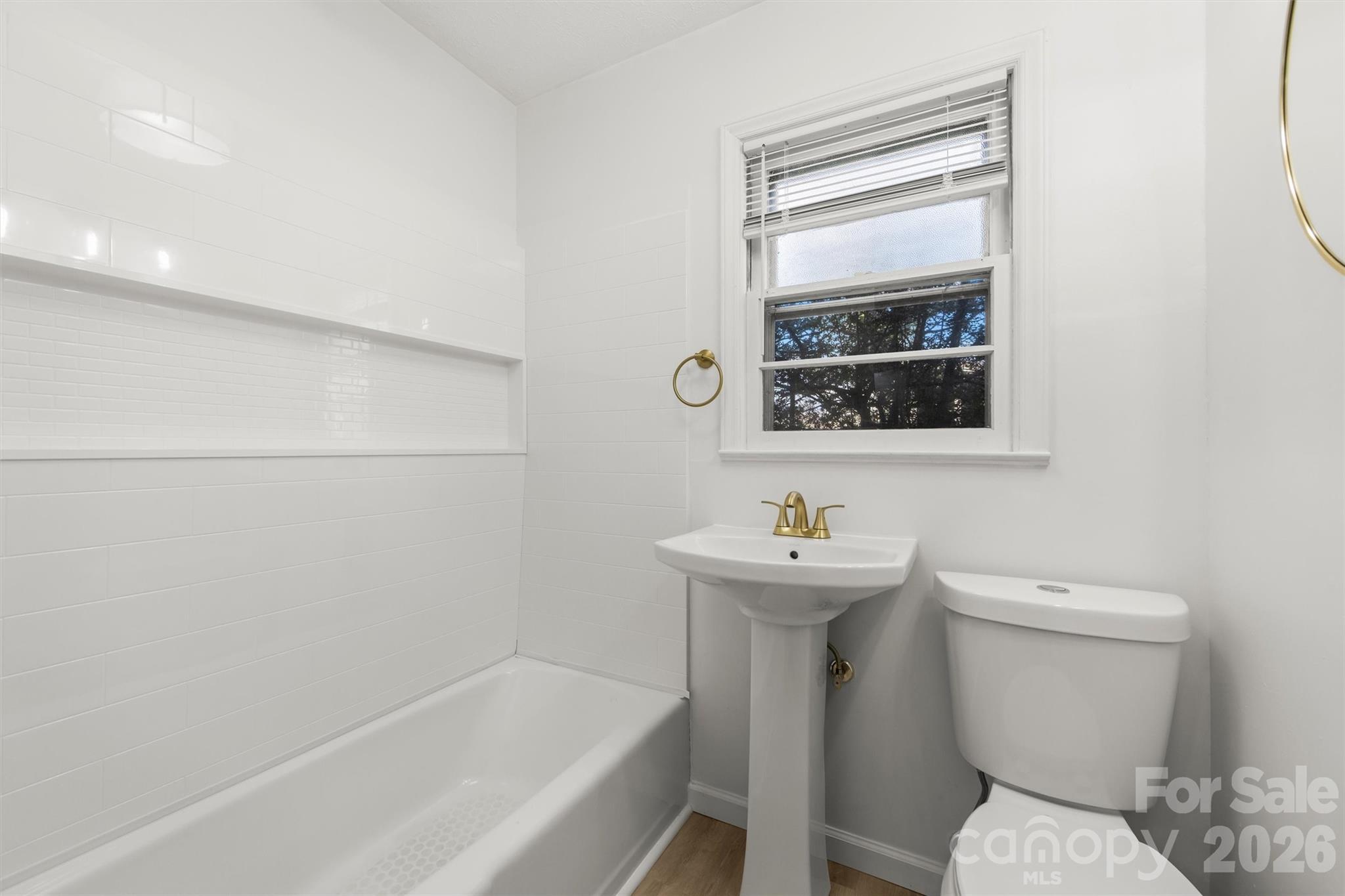 71 Maple Street Clyde, NC 28721 - Photo 10 of 22 a bathroom with a sink a toilet and shower