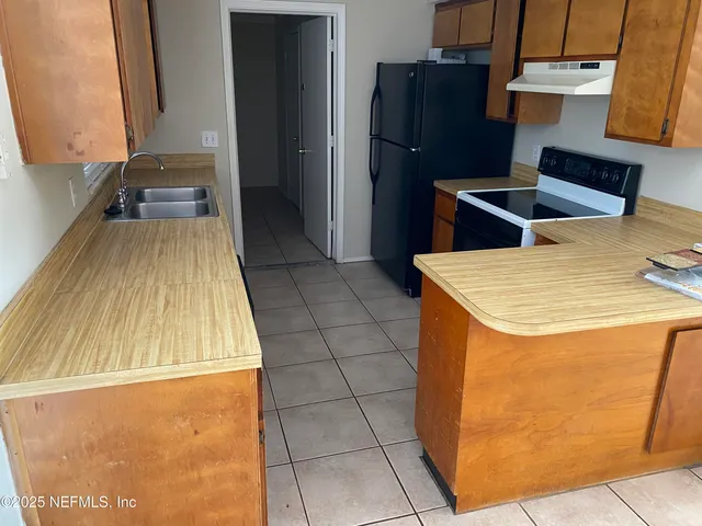 a kitchen with a sink and refrigerator