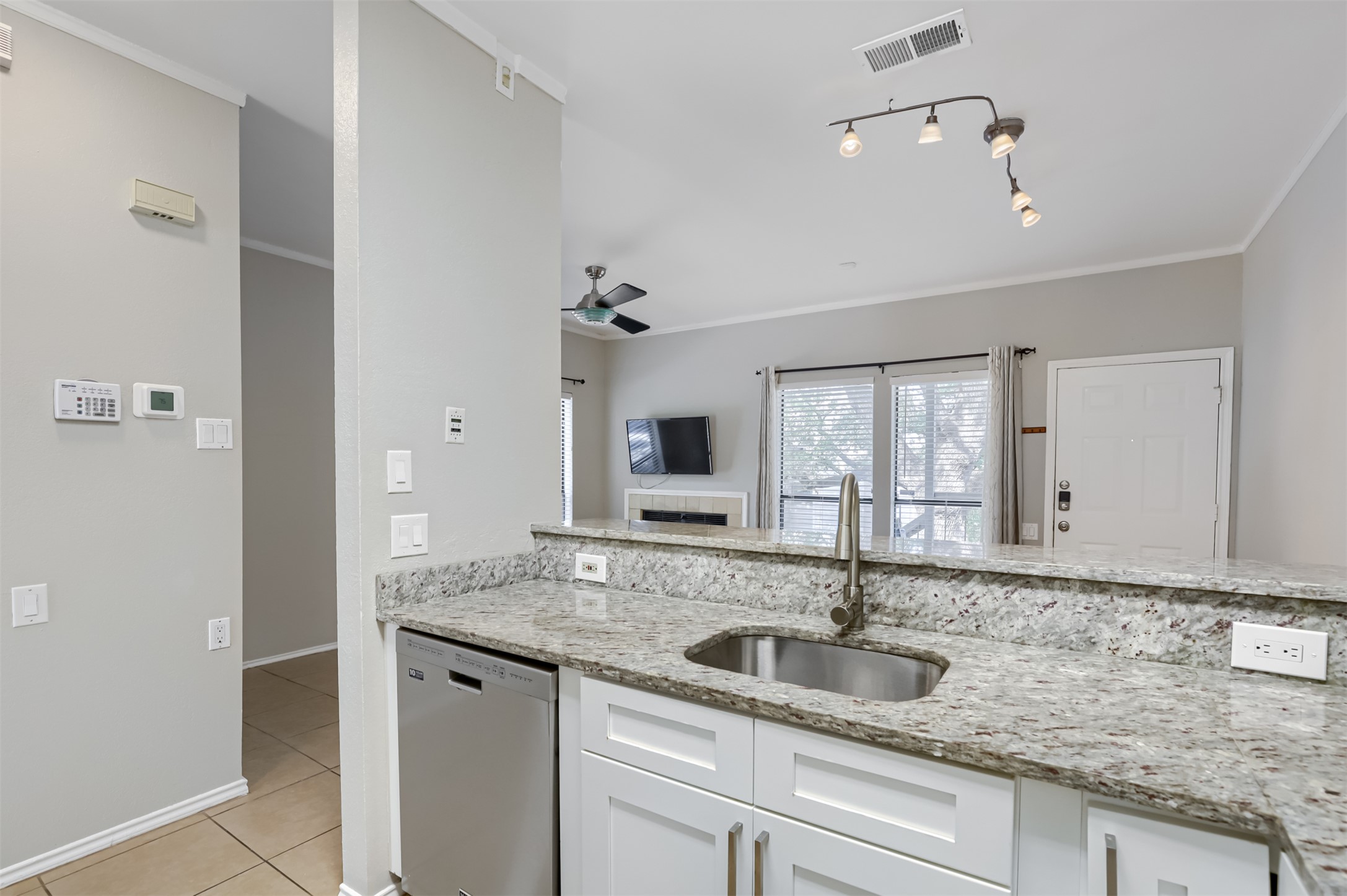 802 South 1st Street, Unit 206 Austin, TX 78704 - Photo 6 of 18 a bathroom with a granite countertop sink and a mirror