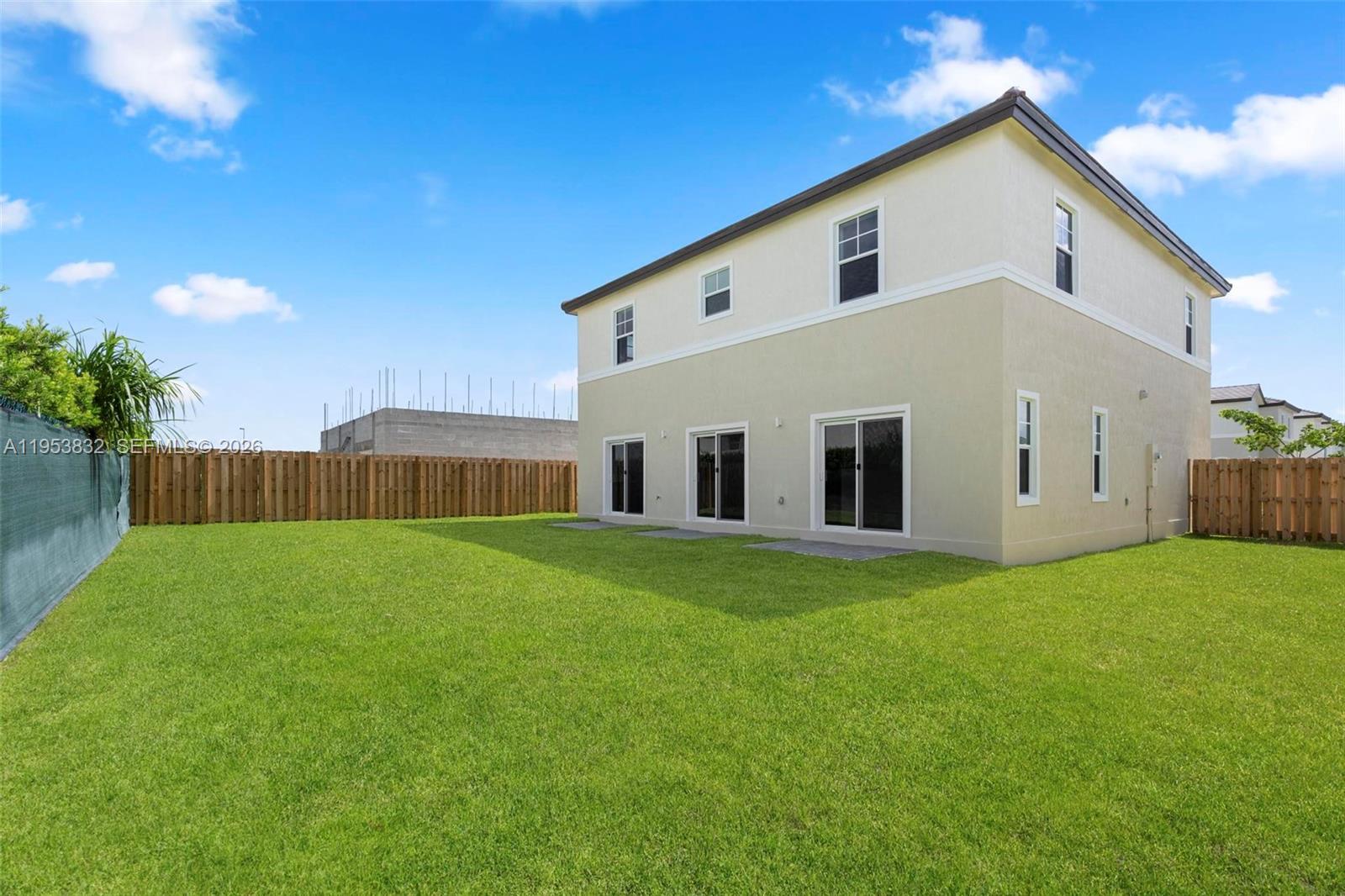 27364 Southwest 133rd Path Homestead, FL 33032 - Photo 34 of 40 a view of a backyard with plants and a garden