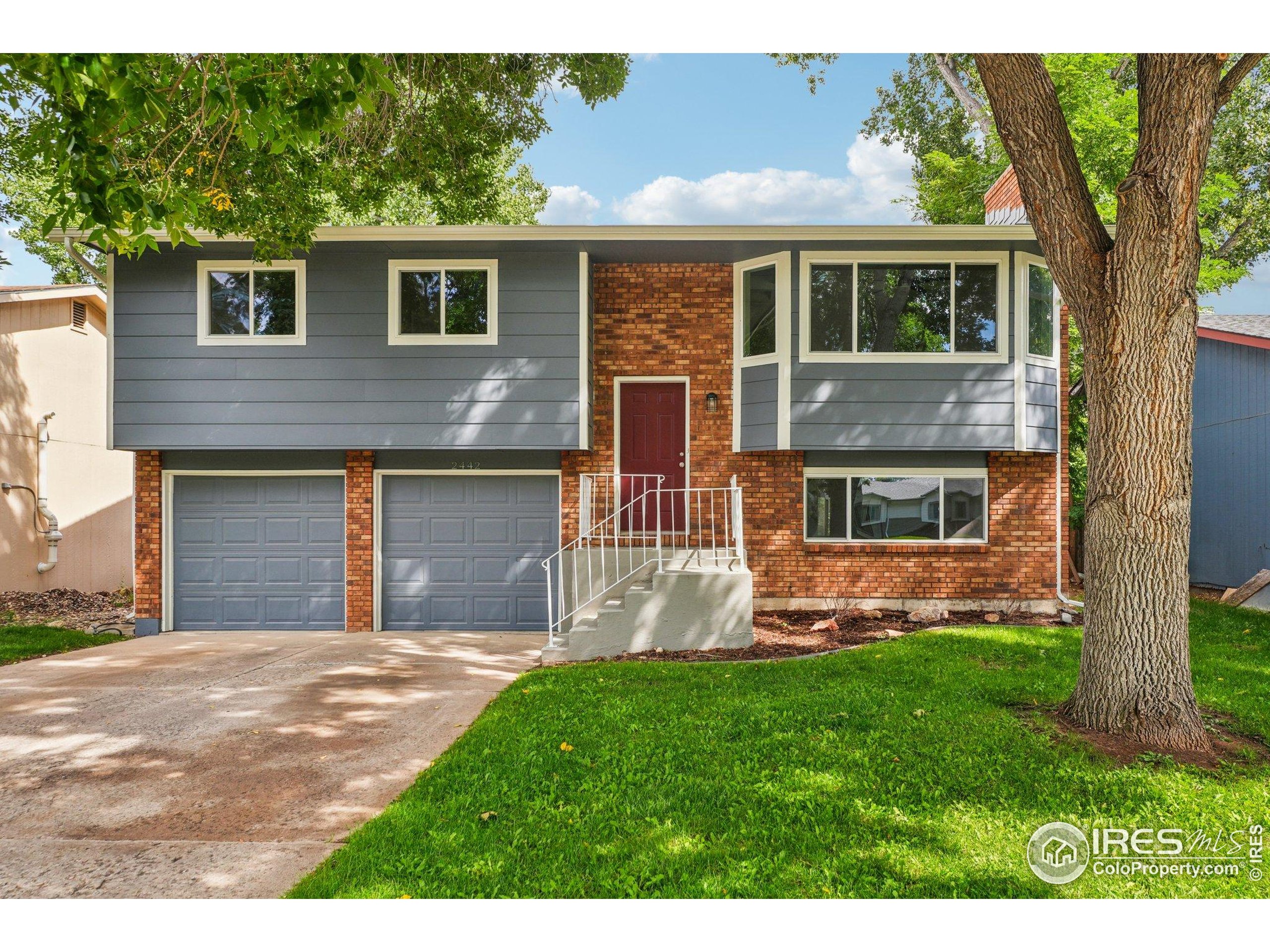 2442 Amherst Street Fort Collins, CO 80525 - Photo 1 of 49 a front view of a house with a garden and yard