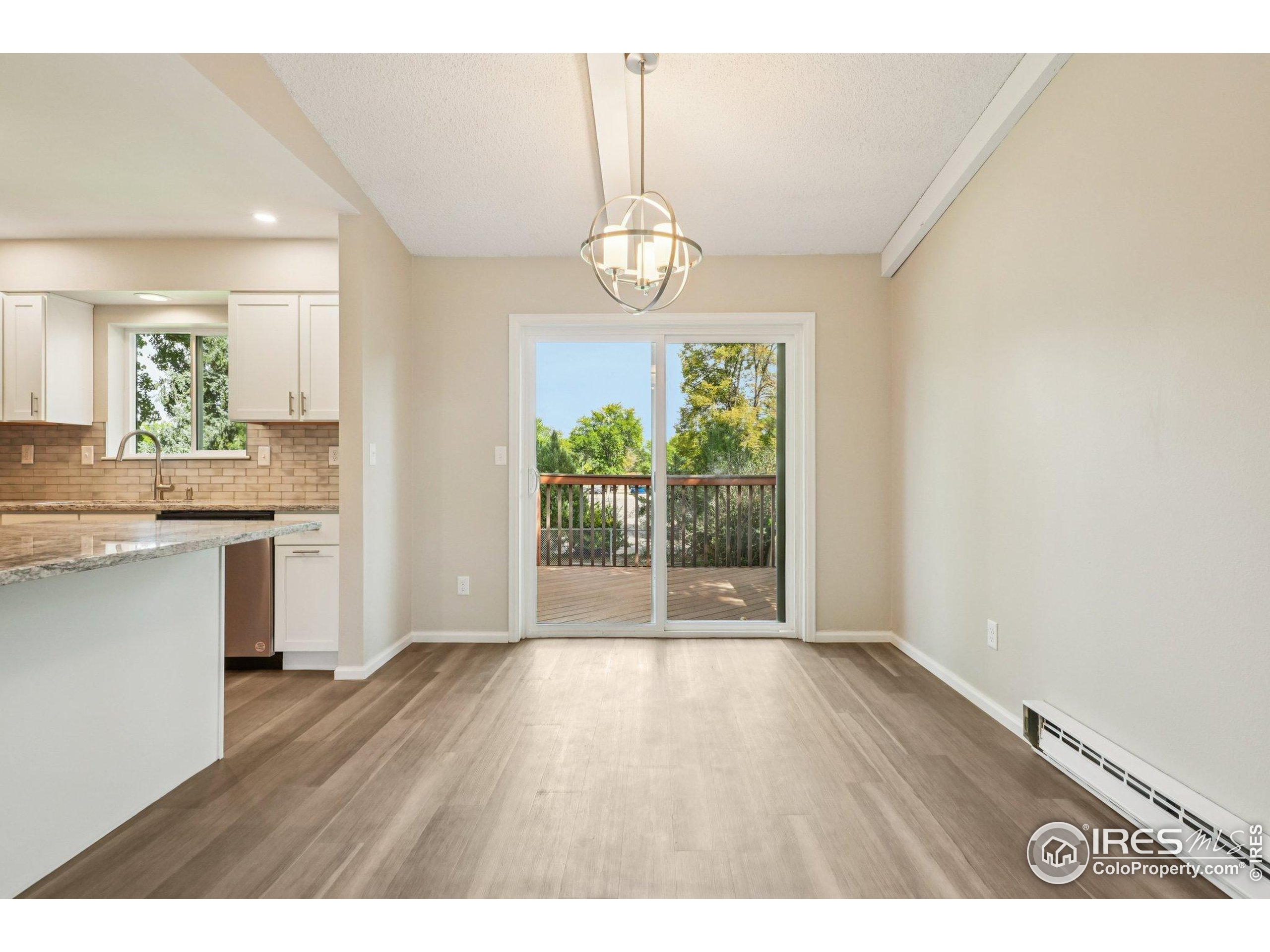 2442 Amherst Street Fort Collins, CO 80525 - Photo 11 of 49 a view of an empty room with wooden floor and a window