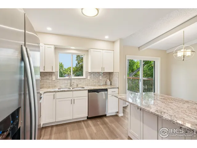a kitchen with a sink stove and refrigerator
