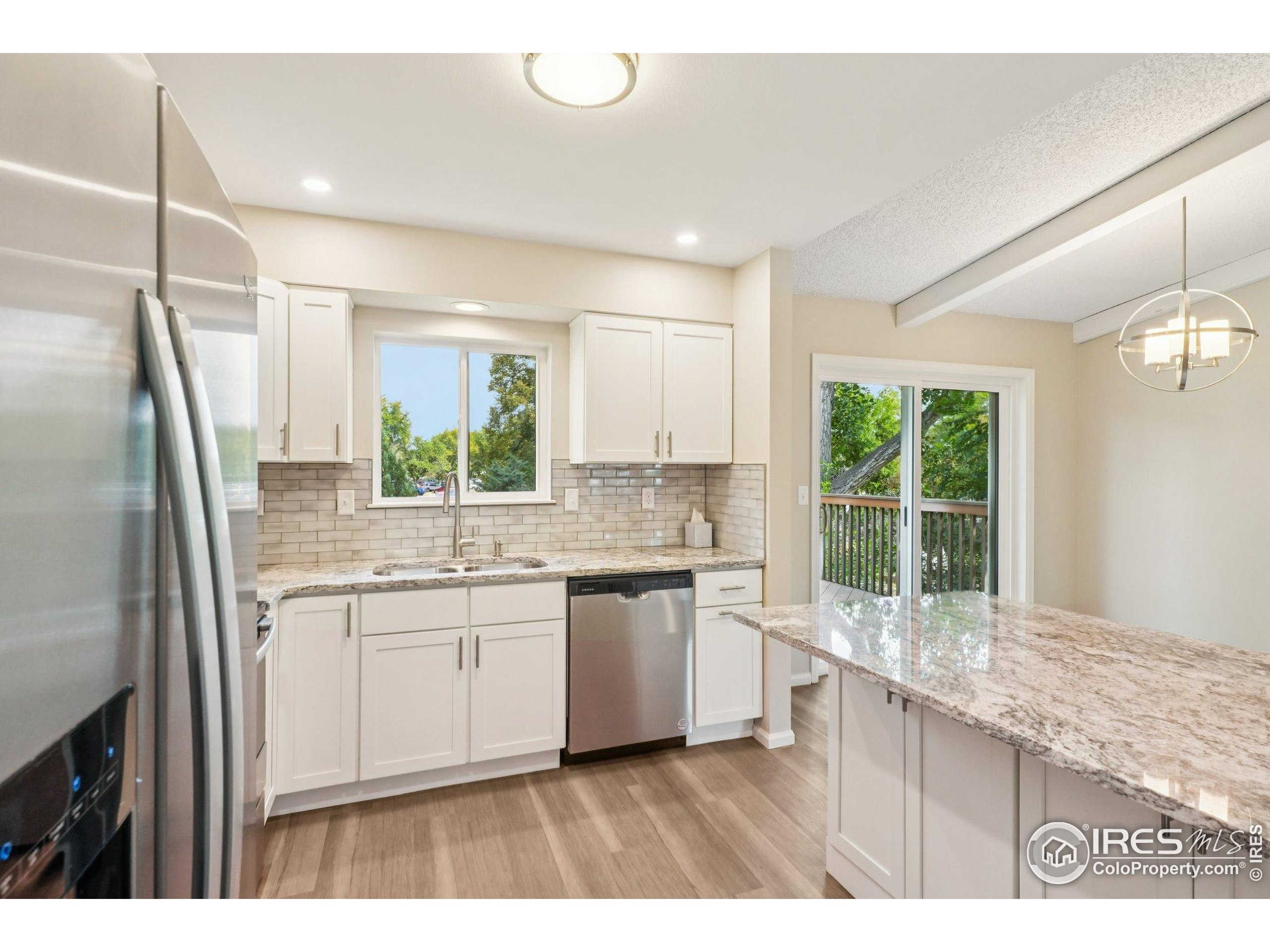 2442 Amherst Street Fort Collins, CO 80525 - Photo 15 of 49 a kitchen with a sink stove and refrigerator