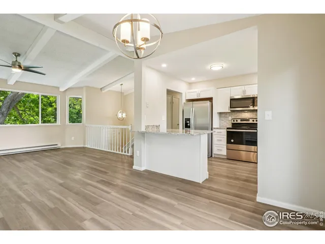 a view of a kitchen with a sink and wooden floor