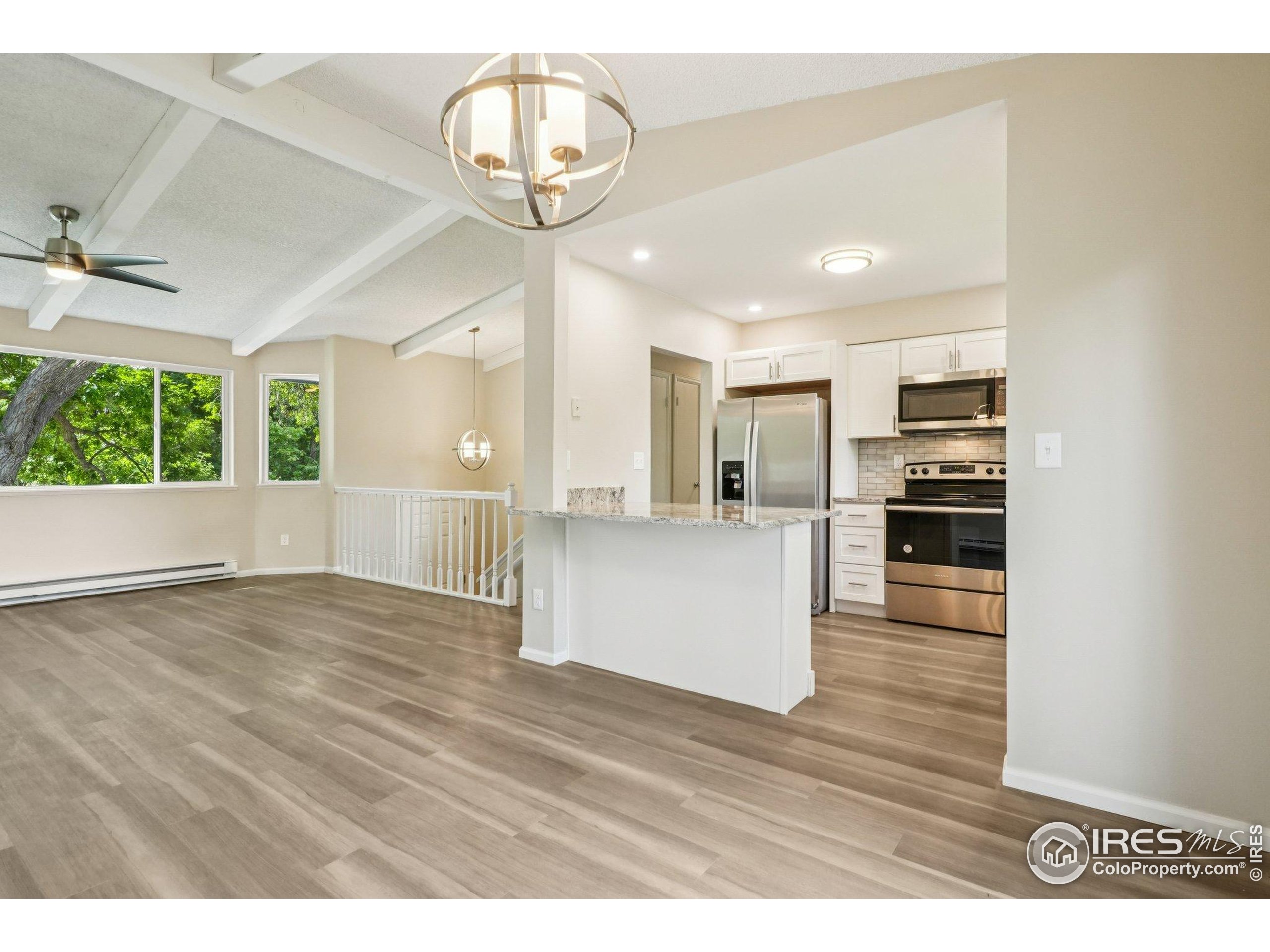 2442 Amherst Street Fort Collins, CO 80525 - Photo 17 of 49 a view of a kitchen with a sink and wooden floor