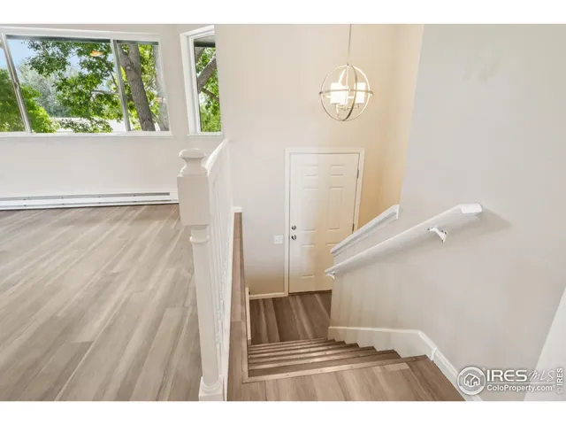 a view of an entryway with wooden floor