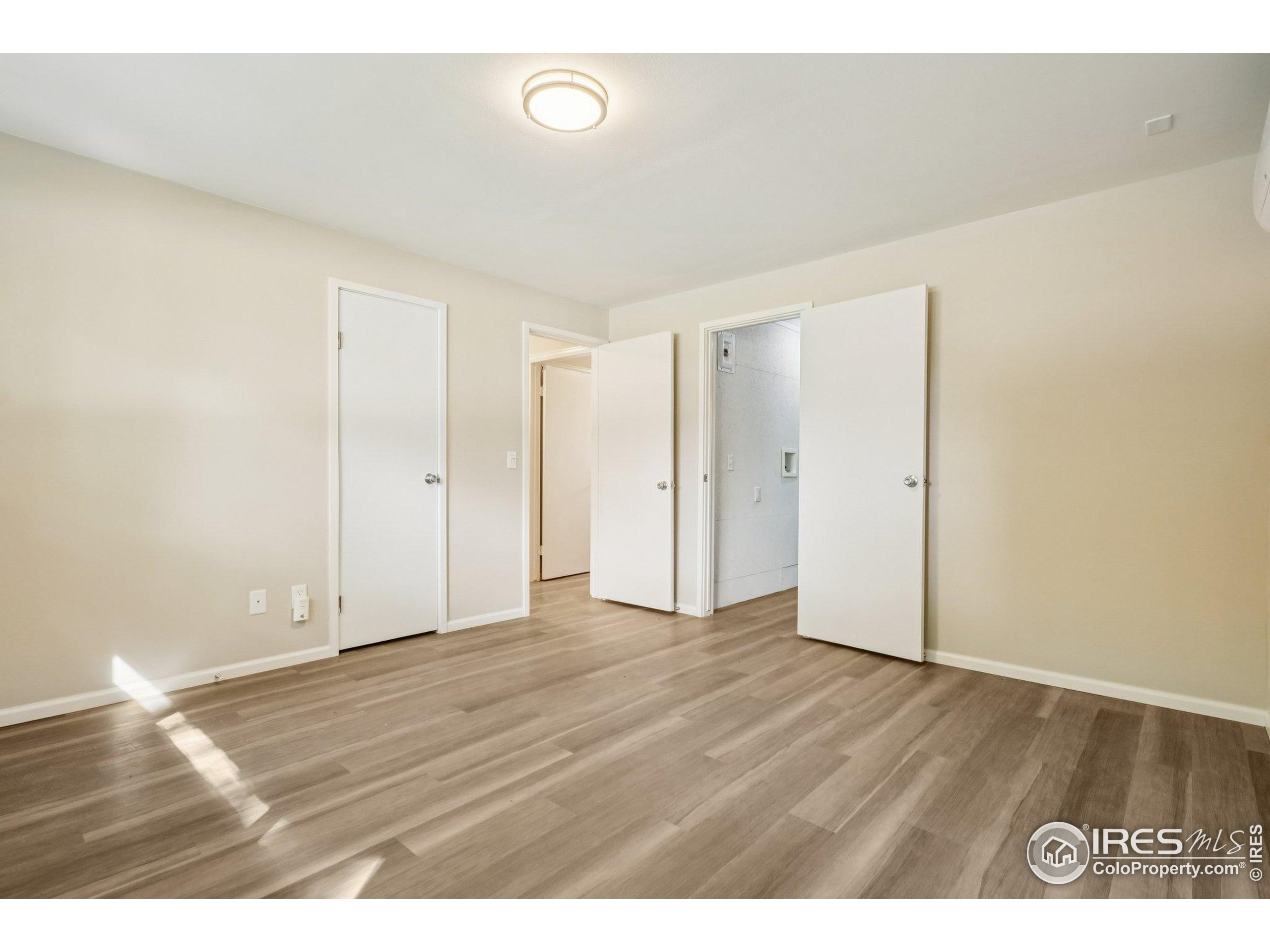 2442 Amherst Street Fort Collins, CO 80525 - Photo 30 of 49 a view of an empty room and wooden floor