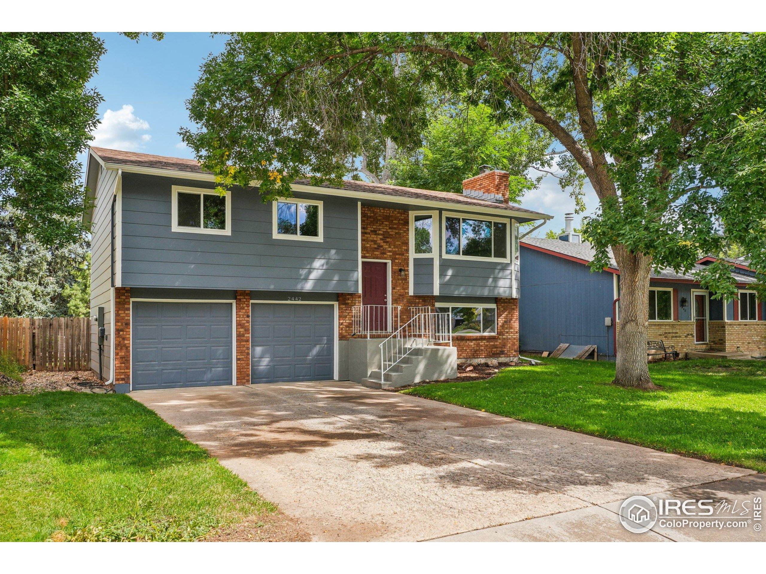 2442 Amherst Street Fort Collins, CO 80525 - Photo 3 of 49 a front view of a house with a garden and yard