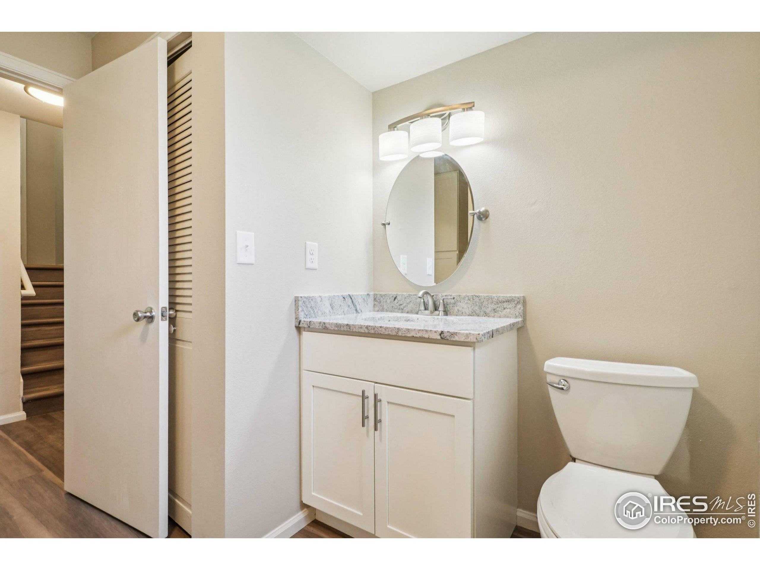 2442 Amherst Street Fort Collins, CO 80525 - Photo 32 of 49 a bathroom with a toilet sink and mirror