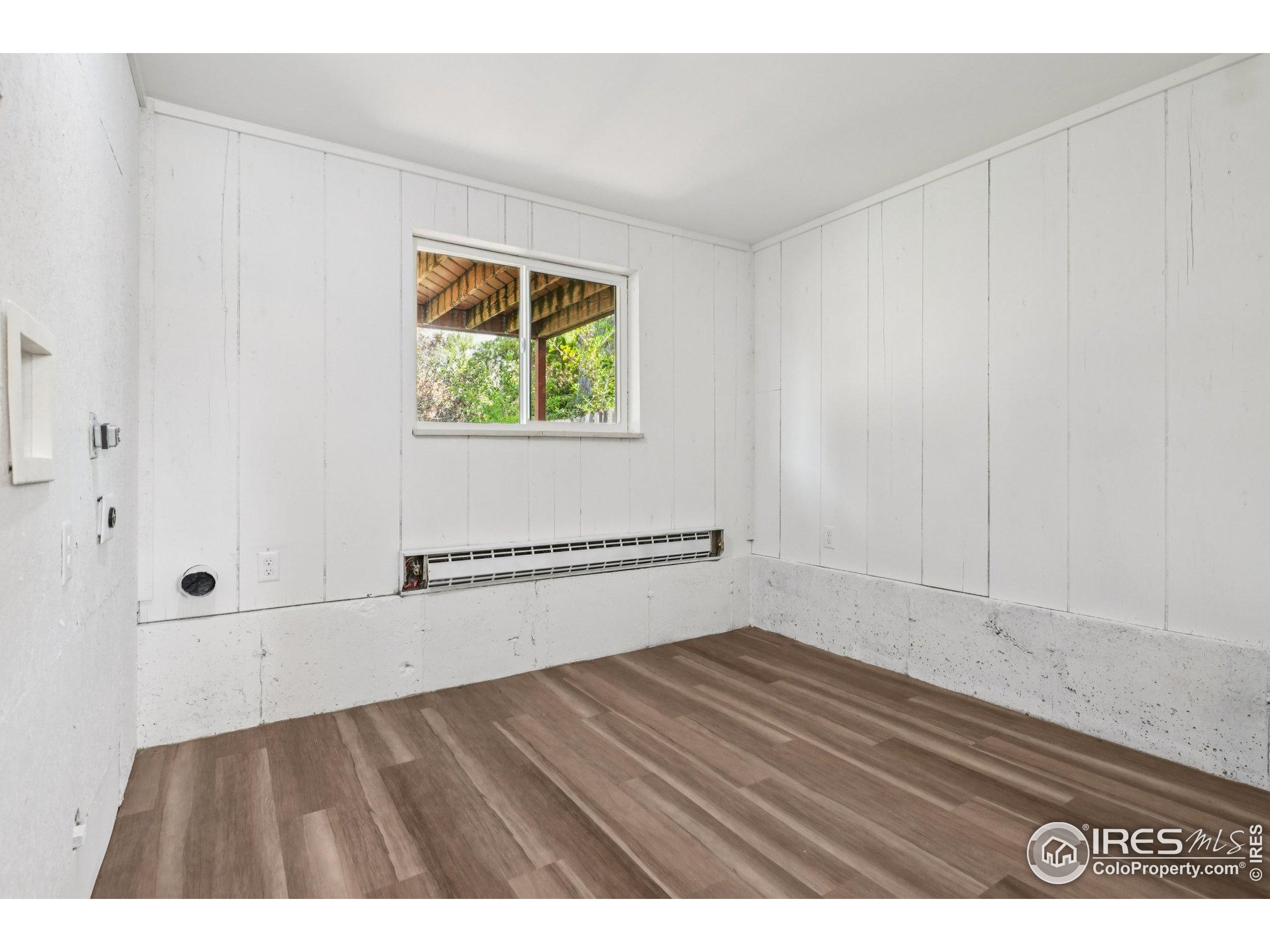 2442 Amherst Street Fort Collins, CO 80525 - Photo 34 of 49 a view of an empty room with wooden floor