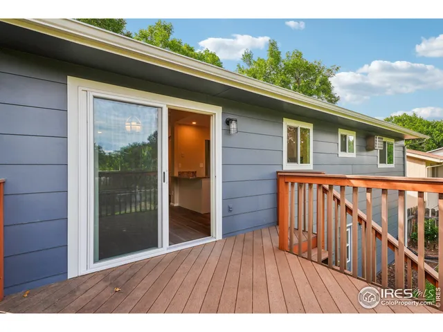 a view of backyard with wooden floor and fence