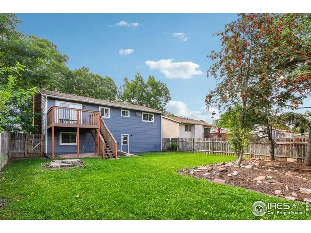 a view of a house with a yard and sitting area
