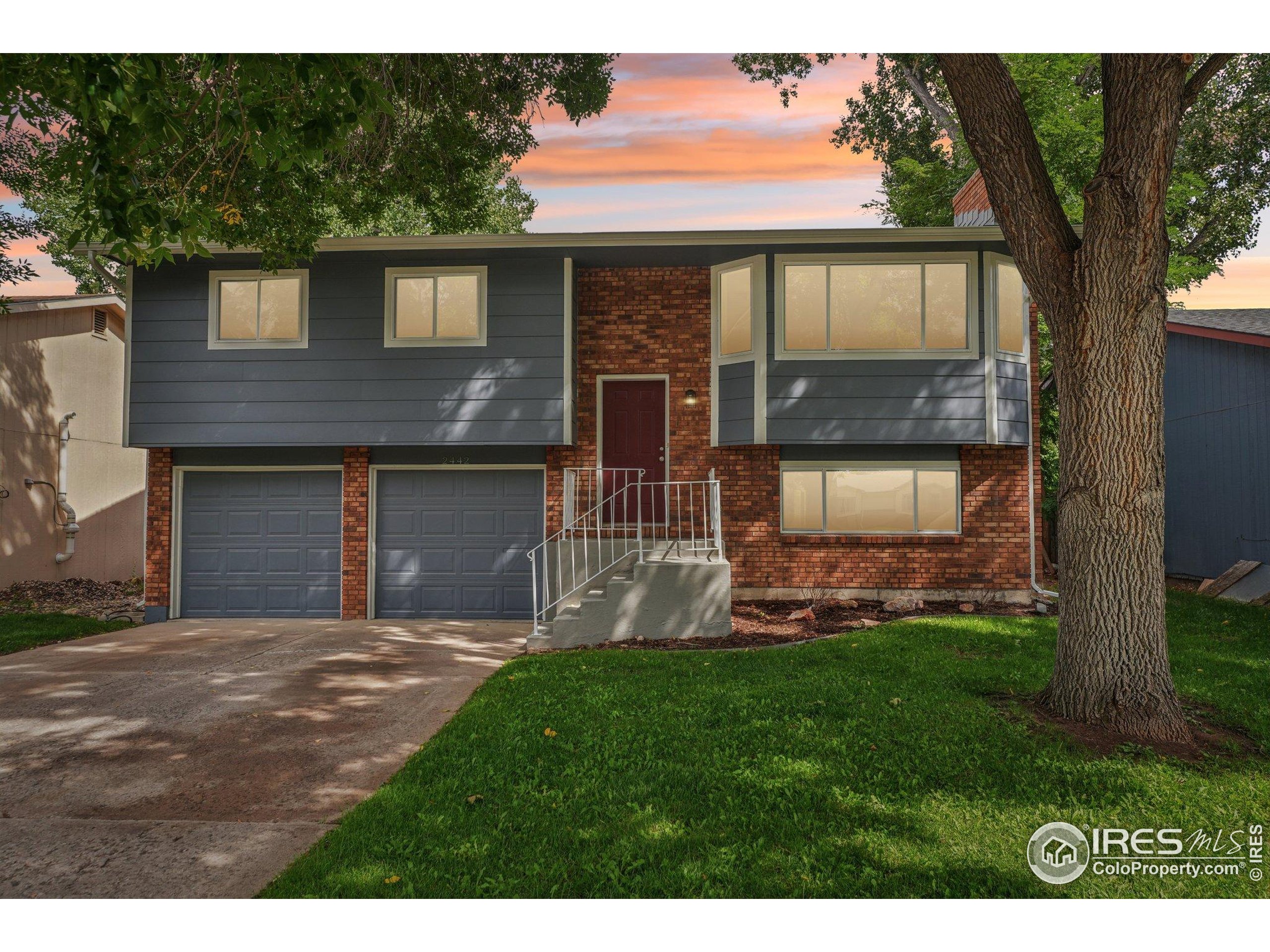2442 Amherst Street Fort Collins, CO 80525 - Photo 47 of 49 a front view of a house with a yard and garage