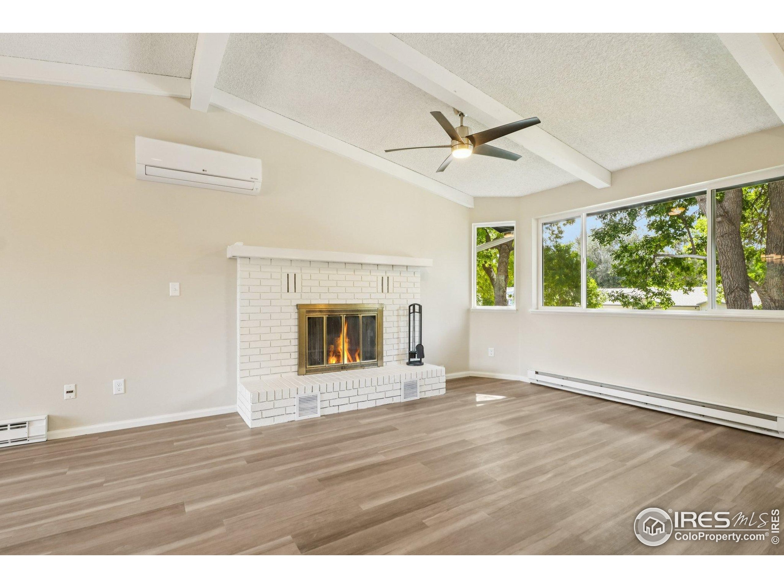 2442 Amherst Street Fort Collins, CO 80525 - Photo 5 of 49 a view of an empty room with wooden floor and a window