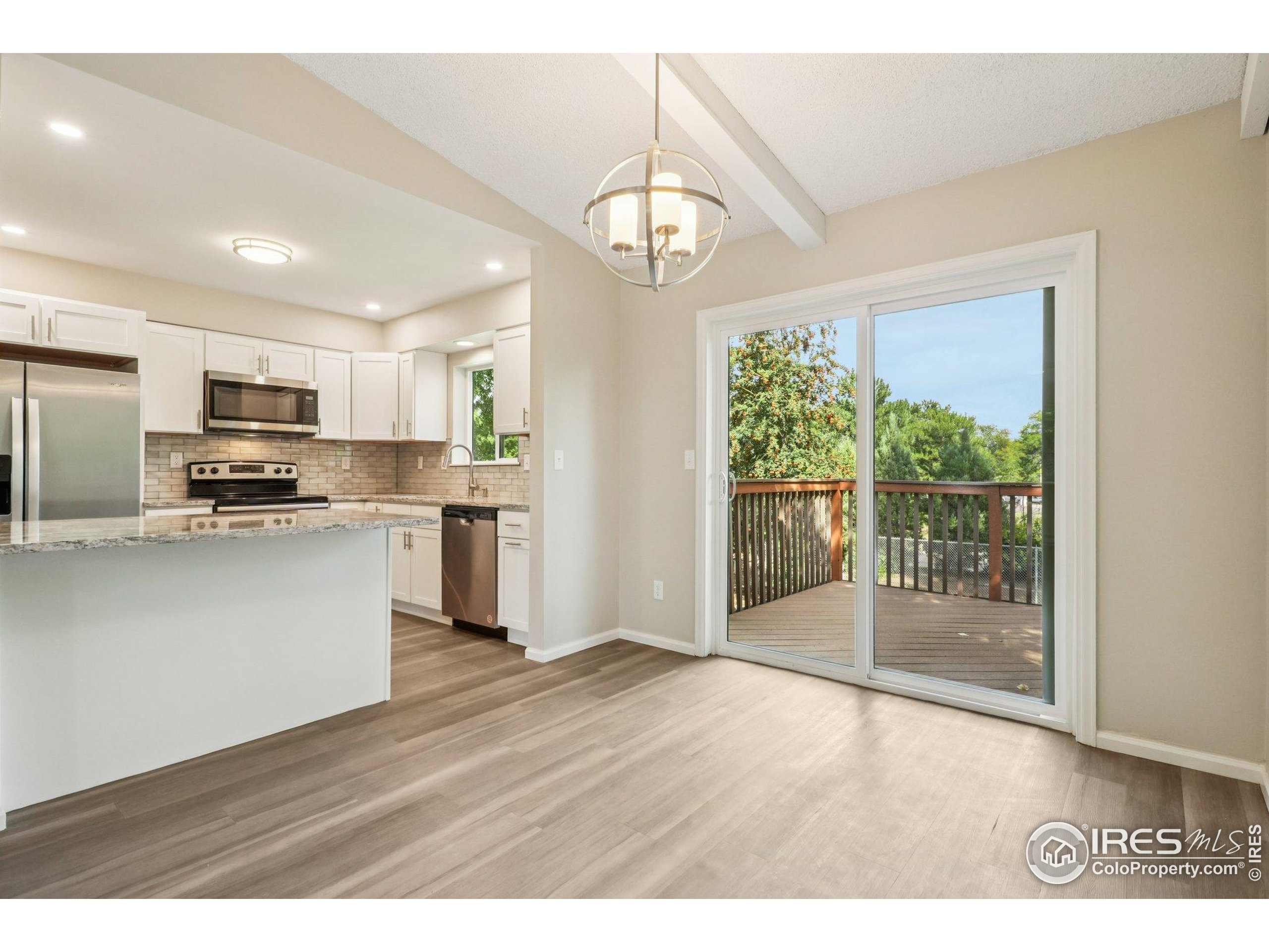 2442 Amherst Street Fort Collins, CO 80525 - Photo 10 of 49 a open kitchen with granite countertop a refrigerator stove top oven and cabinets