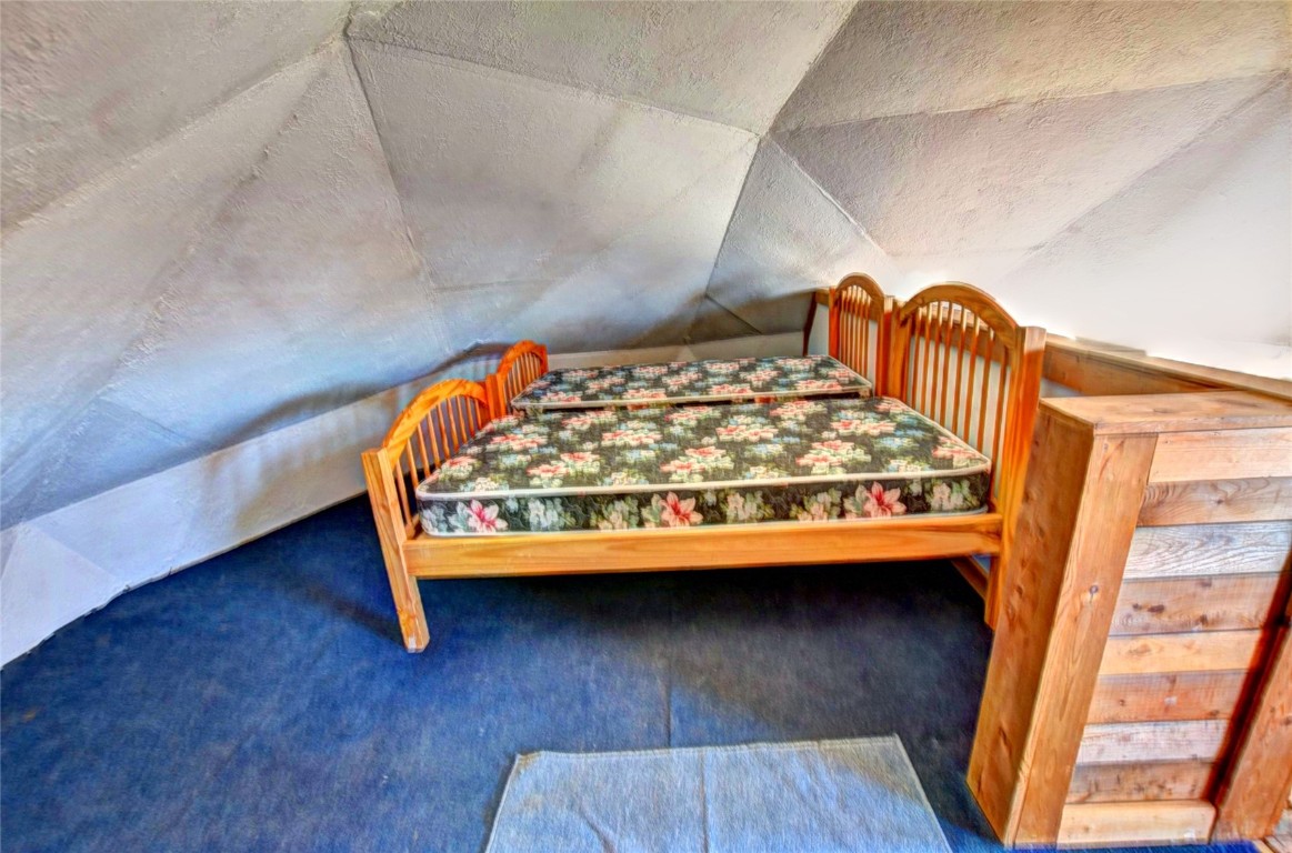 810 Buffalo Ridge Road Como, CO 80432 - Photo 20 of 31 a bedroom with a bed wooden floor and window