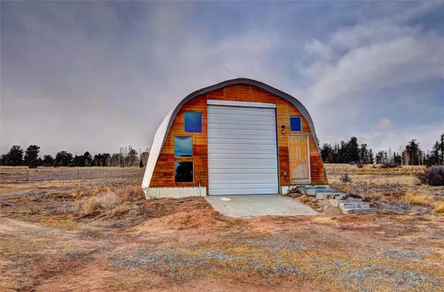 a open kitchen with stainless steel appliances granite countertop a stove and a wooden floors