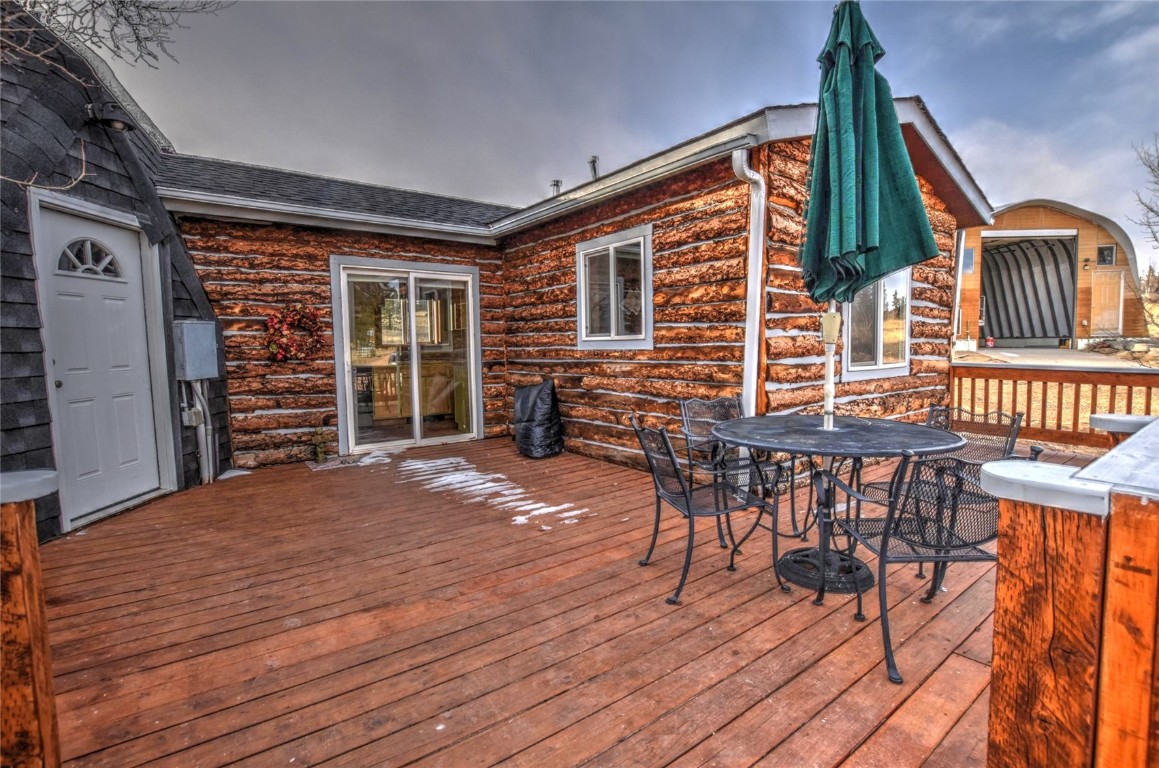 810 Buffalo Ridge Road Como, CO 80432 - Photo 4 of 31 a view of a chairs and table on the wooden floor
