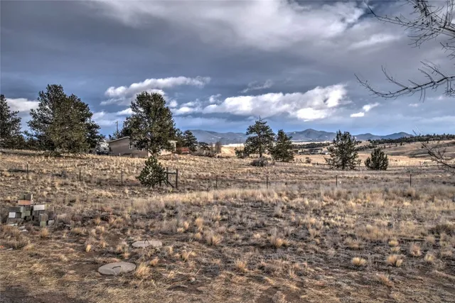 a kitchen with sink a refrigerator and wooden floor