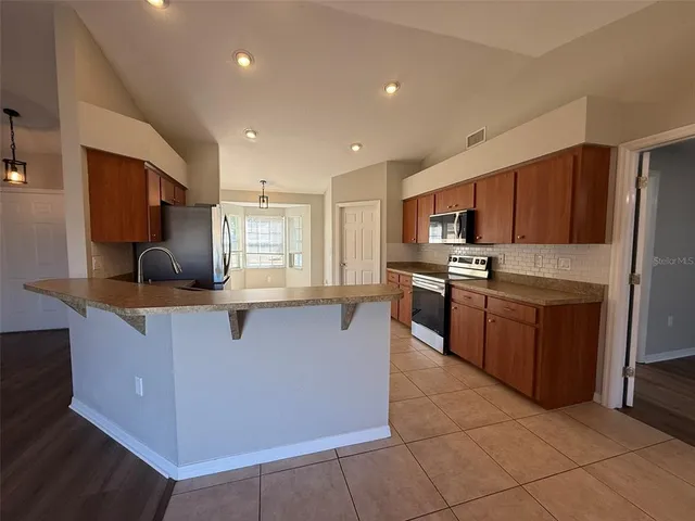 a large kitchen with stainless steel appliances lots of counter top space