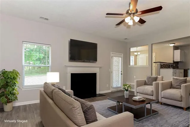 a living room with furniture a fireplace and a flat screen tv