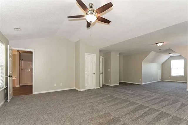 a view of a livingroom with a ceiling fan and window