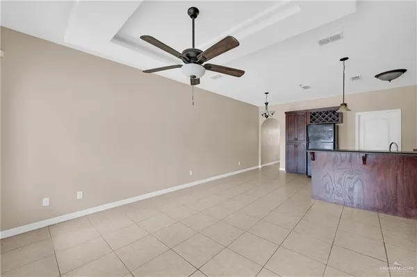 an empty room with a ceiling fan and a ceiling fan