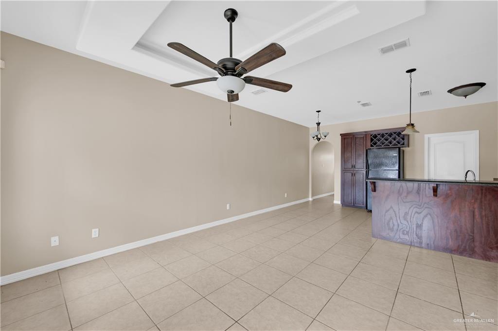 3700 South Embassy Avenue, Unit 3 Pharr, TX 78577 - Photo 2 of 12 an empty room with a ceiling fan and a ceiling fan