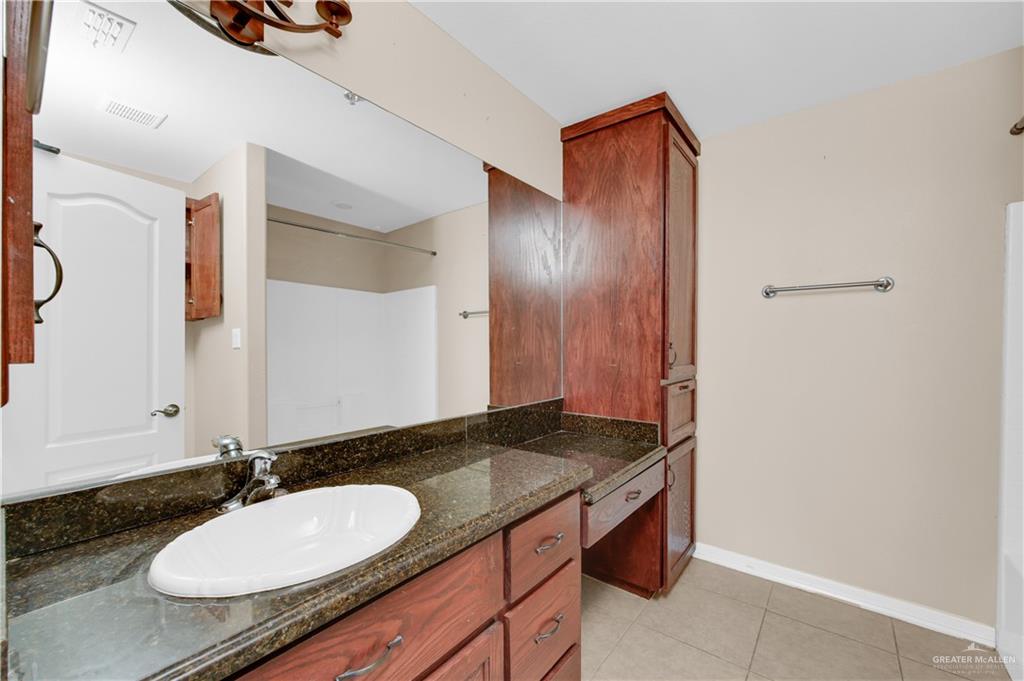 3700 South Embassy Avenue, Unit 3 Pharr, TX 78577 - Photo 10 of 12 a bathroom with a granite countertop sink and a mirror