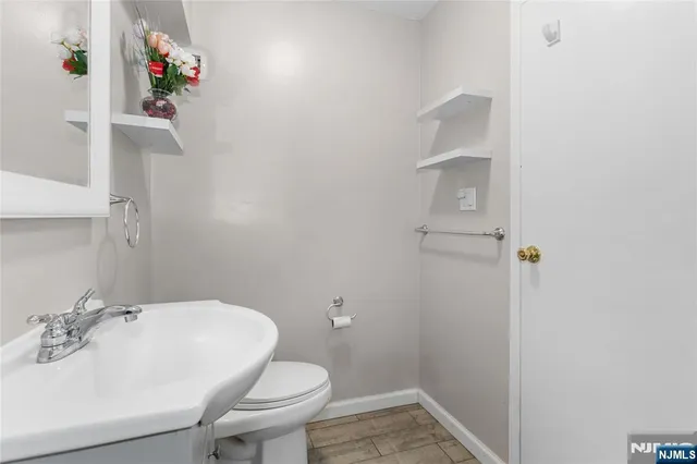 a bathroom with a sink toilet and a mirror