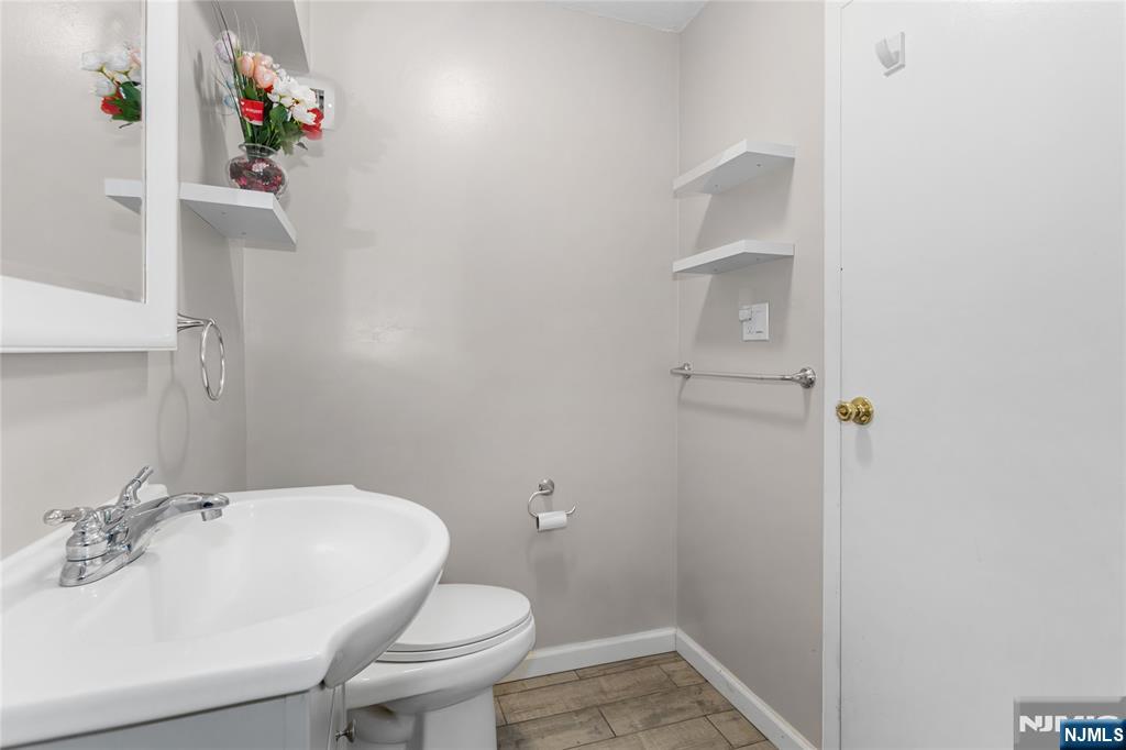 150 Overlook Avenue, Unit 6E Hackensack, NJ 07601 - Photo 17 of 30 a bathroom with a sink toilet and a mirror