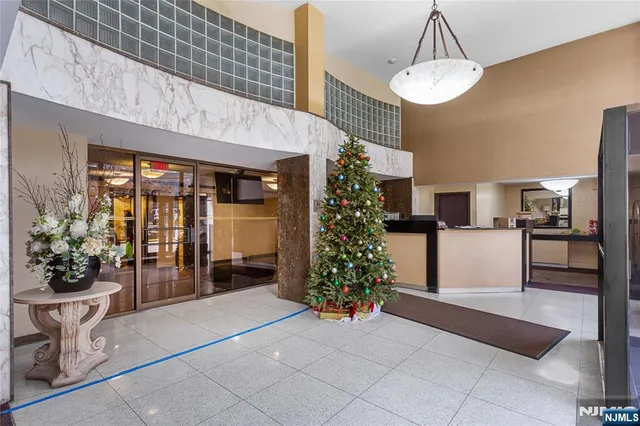 a lobby with furniture and potted plants