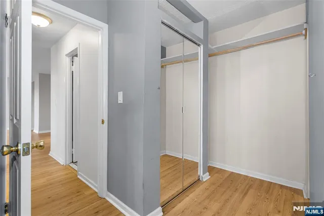 a view of a room with wooden floor and a bathroom