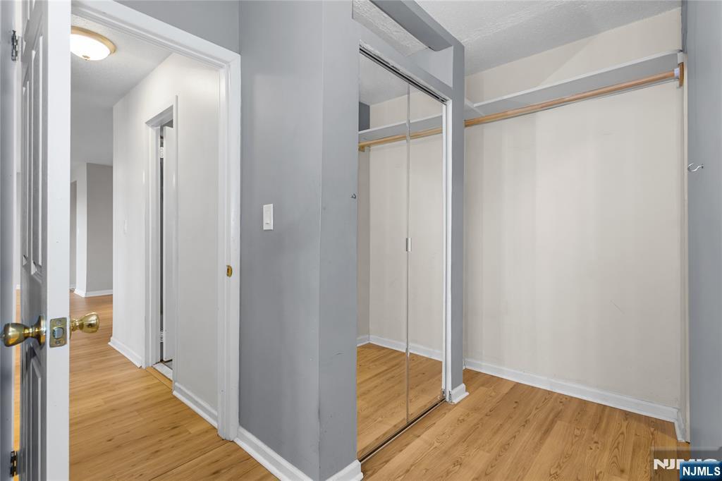 150 Overlook Avenue, Unit 6E Hackensack, NJ 07601 - Photo 21 of 30 a view of a room with wooden floor and a bathroom