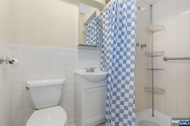 a white toilet sitting next to a bathroom sink