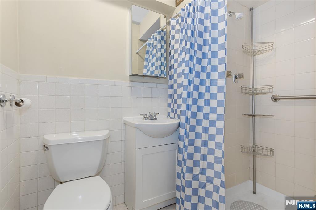 150 Overlook Avenue, Unit 6E Hackensack, NJ 07601 - Photo 22 of 30 a white toilet sitting next to a bathroom sink