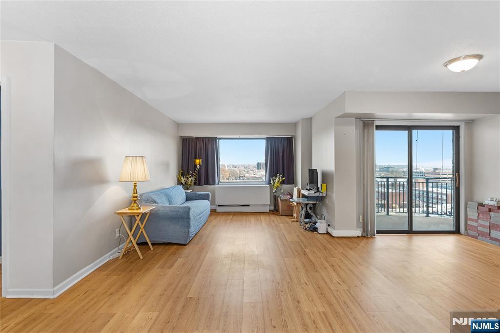 150 Overlook Avenue, Unit 6E Hackensack, NJ 07601 - Photo 7 of 30 a living room with furniture and a wooden floor