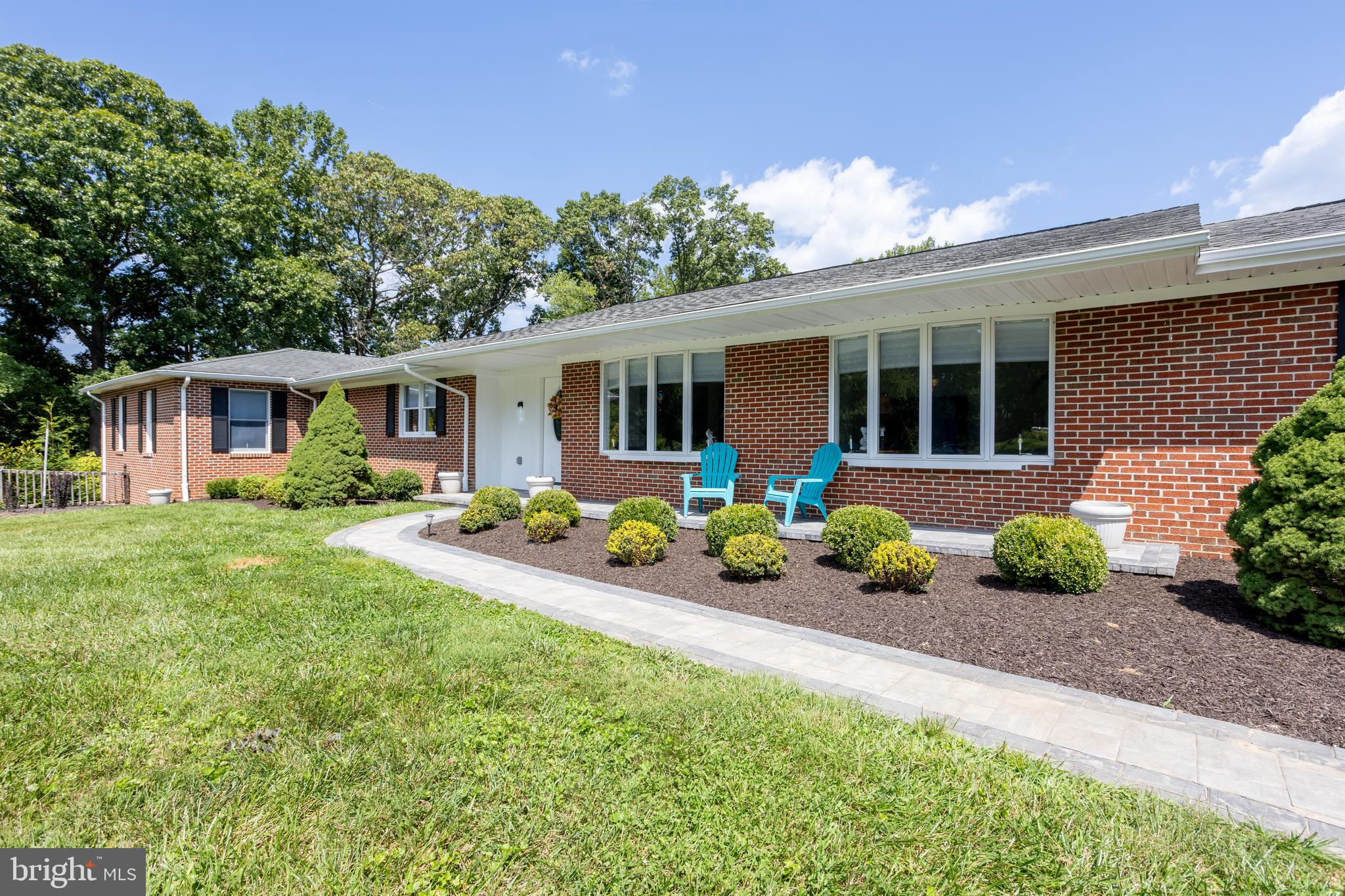 a front view of house with yard and outdoor seating